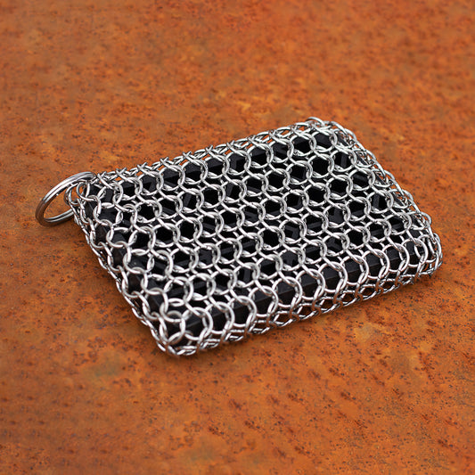 A No.3 chainmail scouring pad on a rusted surface.